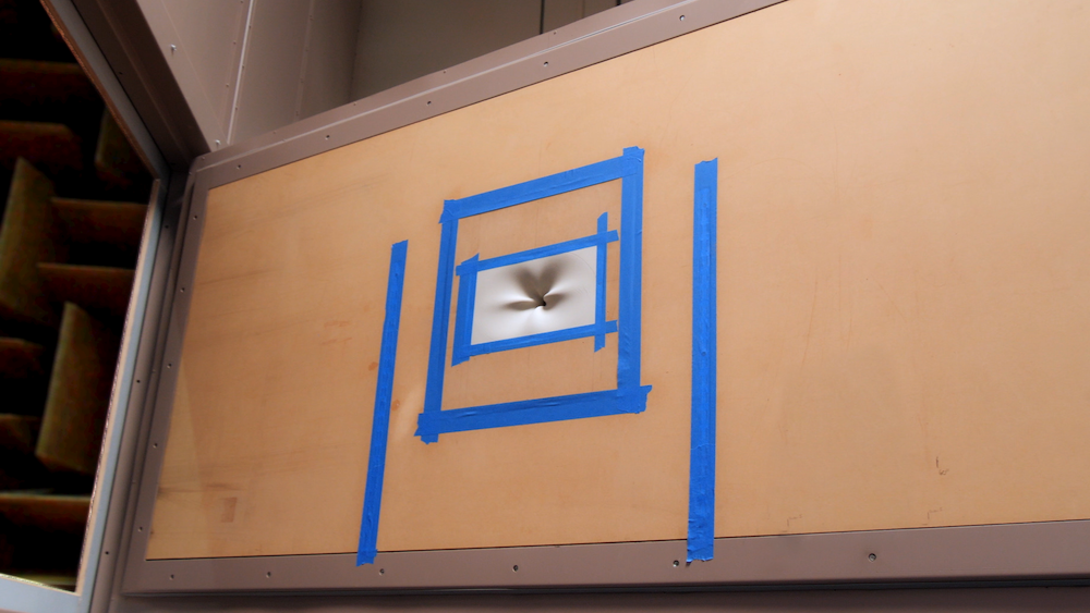 Wall mounted A photograph of an anechoic chamber with a solid wall.